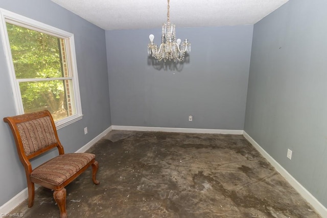 4984 US Highway 220, Asheboro, NC 27205 - empty room featuring a chandelier, unfinished concrete floors, baseboards, and a textured ceiling