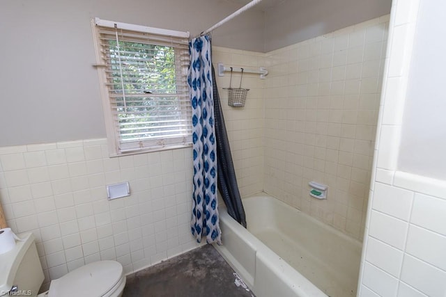 4984 US Highway 220, Asheboro, NC 27205 - bathroom featuring tile walls, toilet, shower / bath combination with curtain, a wainscoted wall, and concrete flooring