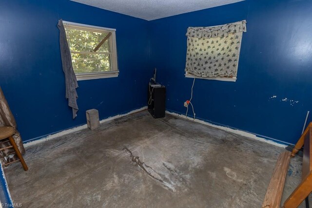 4984 US Highway 220, Asheboro, NC 27205 - unfurnished room with a textured ceiling, unfinished concrete floors, and baseboards