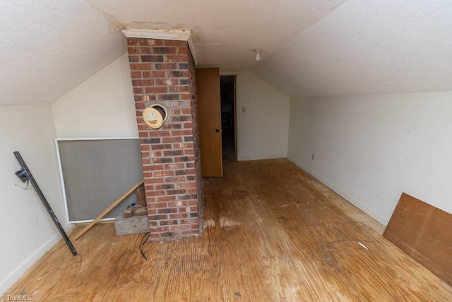 4984 US Highway 220, Asheboro, NC 27205 - additional living space with lofted ceiling, hardwood / wood-style floors, a textured ceiling, and baseboards