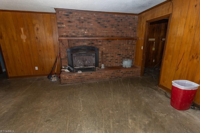 4984 US Highway 220, Asheboro, NC 27205 - unfurnished living room featuring wooden walls, a textured ceiling, a wood stove, baseboards, and ornamental molding