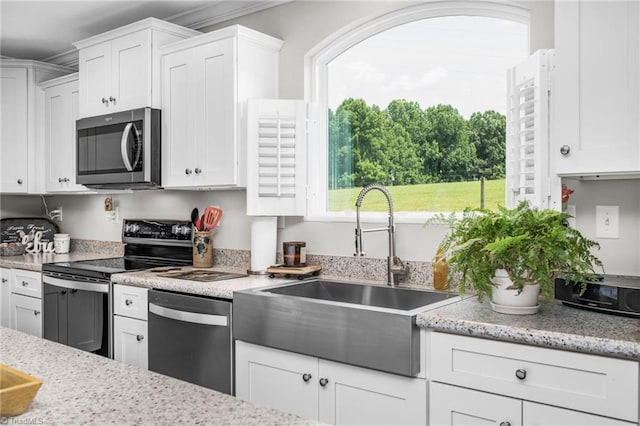742 Teague Rd, Winston-Salem, NC 27107 - kitchen with stainless steel appliances, white cabinetry, and light stone counters