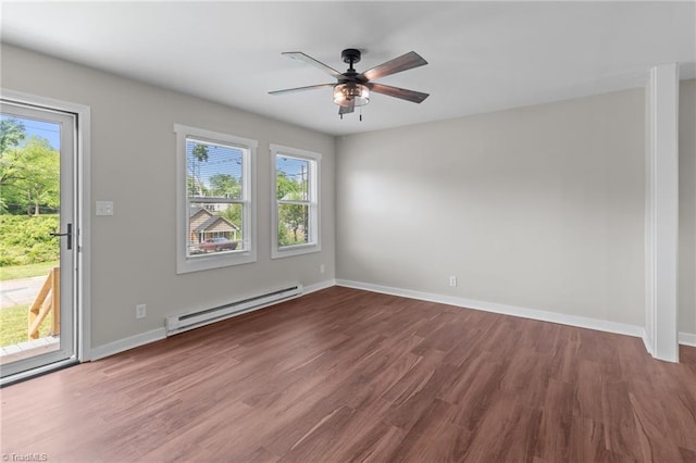 empty room featuring a baseboard heating unit, ceiling fan, wood finished floors, and baseboards