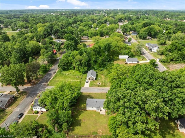 view of property location with a forest