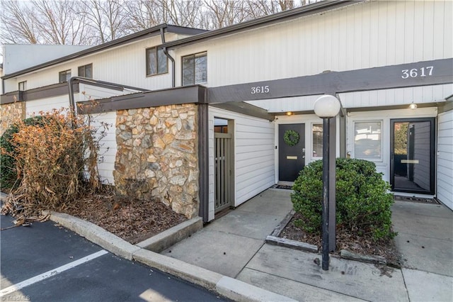 property entrance with stone siding