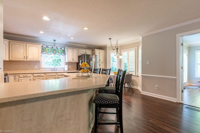 97 Shadylawn Dr, Winston-Salem, NC 27104 - kitchen featuring freestanding refrigerator, dark wood finished floors, a kitchen bar, decorative backsplash, and light countertops