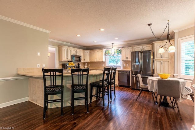 97 Shadylawn Dr, Winston-Salem, NC 27104 - kitchen with stainless steel appliances, a peninsula, healthy amount of natural light, dark wood-type flooring, and ornamental molding
