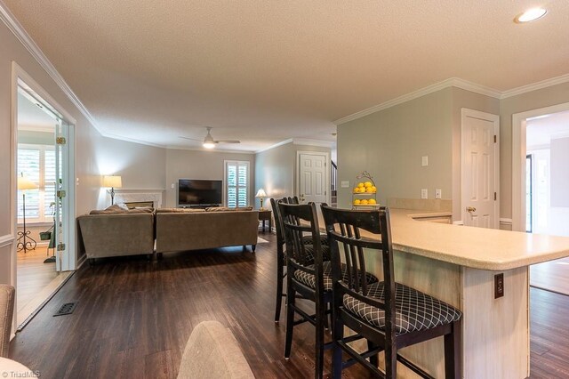 97 Shadylawn Dr, Winston-Salem, NC 27104 - dining area featuring dark wood finished floors, healthy amount of natural light, ceiling fan, and crown molding