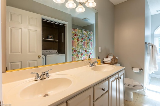 97 Shadylawn Dr, Winston-Salem, NC 27104 - bathroom featuring washer and clothes dryer, tile patterned floors, double vanity, and a chandelier