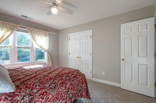 97 Shadylawn Dr, Winston-Salem, NC 27104 - carpeted bedroom with a textured ceiling, ceiling fan, and a closet