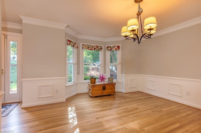 97 Shadylawn Dr, Winston-Salem, NC 27104 - unfurnished room with light wood-style flooring, a chandelier, a wainscoted wall, and crown molding