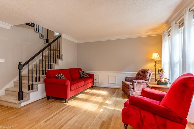 97 Shadylawn Dr, Winston-Salem, NC 27104 - living room featuring wood finished floors, stairway, crown molding, a wainscoted wall, and a textured ceiling