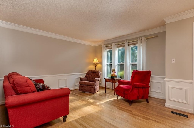 97 Shadylawn Dr, Winston-Salem, NC 27104 - living area with crown molding, light wood-style flooring, wainscoting, and a textured ceiling
