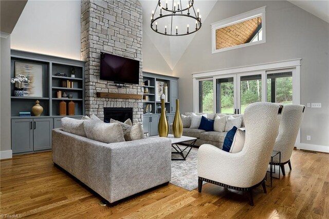 living room with high vaulted ceiling, plenty of natural light, and a stone fireplace