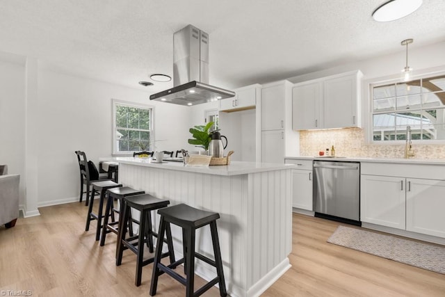 317 Benbow Dr, East Bend, NC 27018 - kitchen featuring stainless steel dishwasher, island exhaust hood, a sink, tasteful backsplash, and white cabinets