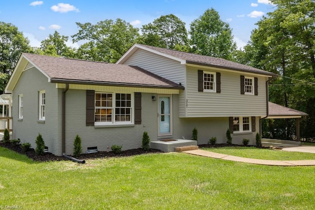 317 Benbow Dr, East Bend, NC 27018 - tri-level home with brick siding, a front lawn, roof with shingles, and an attached carport