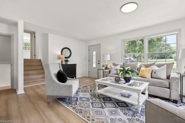 317 Benbow Dr, East Bend, NC 27018 - living room featuring plenty of natural light, light wood-style floors, stairs, and baseboards