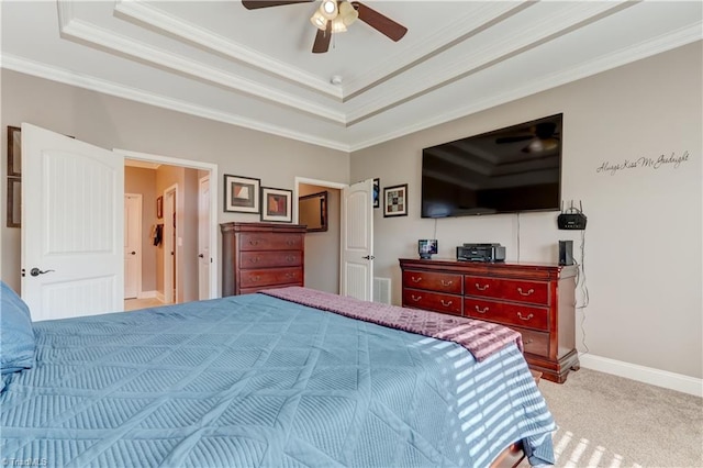 carpeted bedroom with ceiling fan, a raised ceiling, and ornamental molding