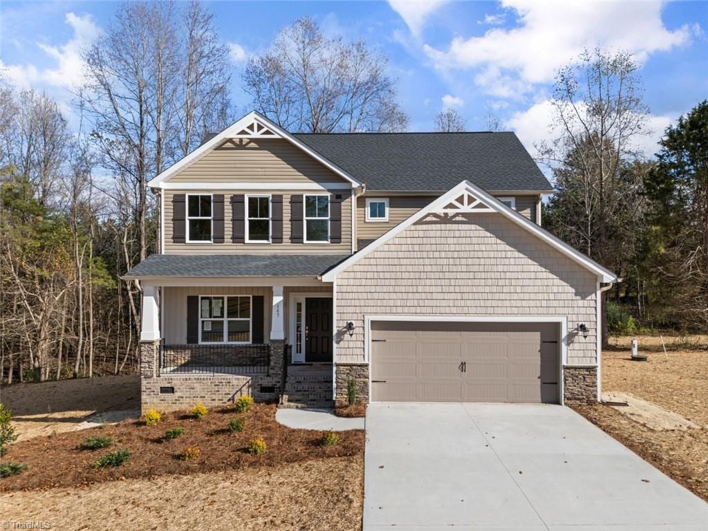 craftsman-style home featuring a porch and a garage