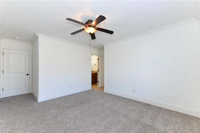 spare room featuring ceiling fan, light carpet, and crown molding