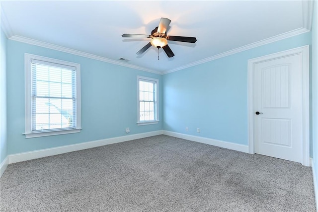 empty room with carpet, crown molding, and a wealth of natural light