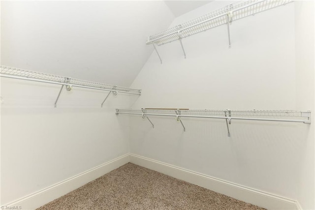 walk in closet with carpet flooring and lofted ceiling