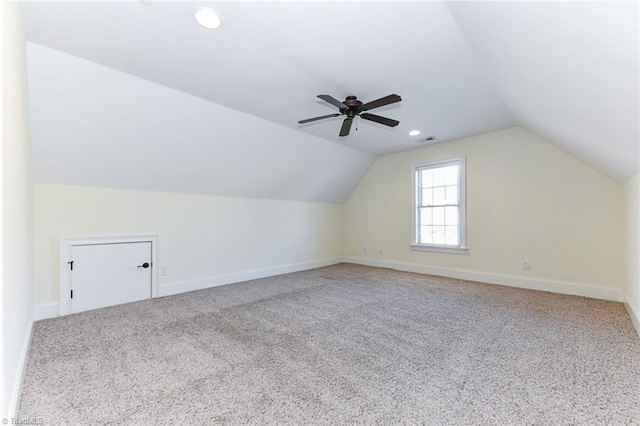 additional living space with vaulted ceiling, carpet, and ceiling fan