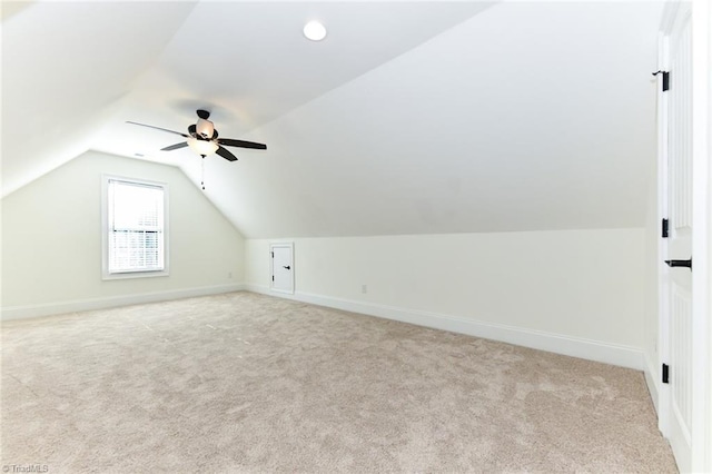 additional living space featuring vaulted ceiling, ceiling fan, and light carpet