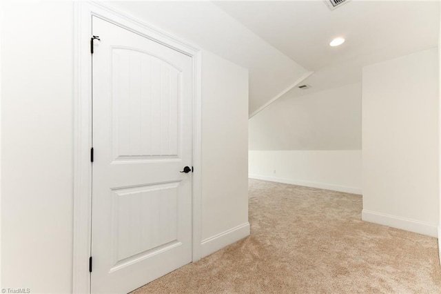 bonus room with light colored carpet and lofted ceiling