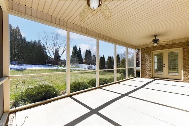 unfurnished sunroom with ceiling fan and french doors