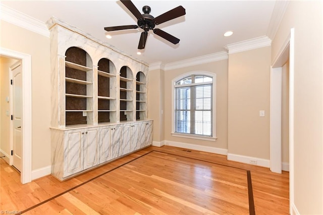 unfurnished room featuring ceiling fan, wood-type flooring, and ornamental molding