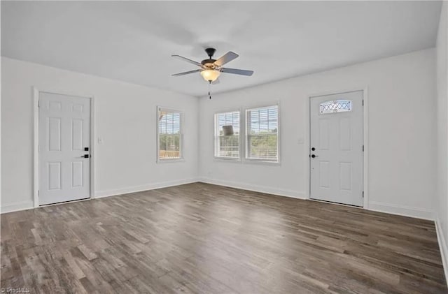 interior space with baseboards, wood finished floors, and ceiling fan