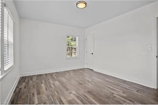 empty room with baseboards and wood finished floors