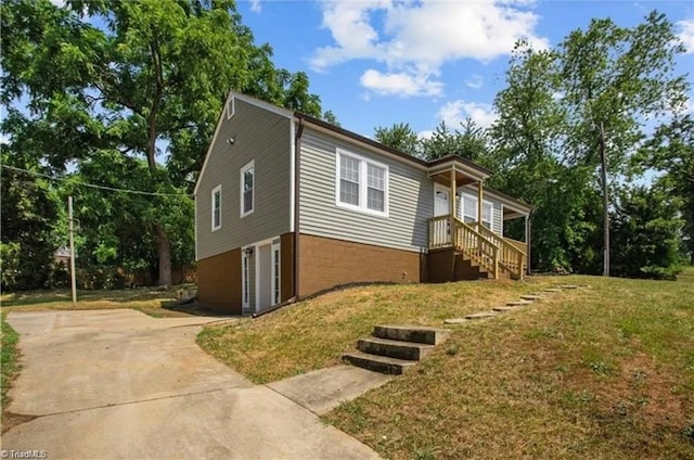 view of home's exterior featuring a yard and concrete driveway