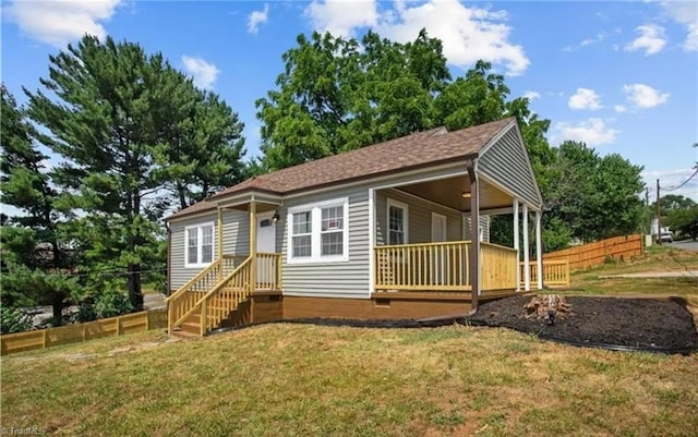 view of front facade with crawl space, fence, and a front lawn