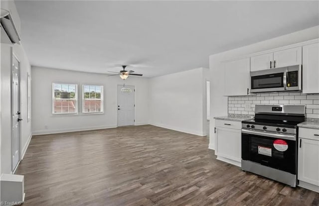kitchen featuring dark wood-style flooring, white cabinetry, backsplash, ceiling fan, and stainless steel appliances