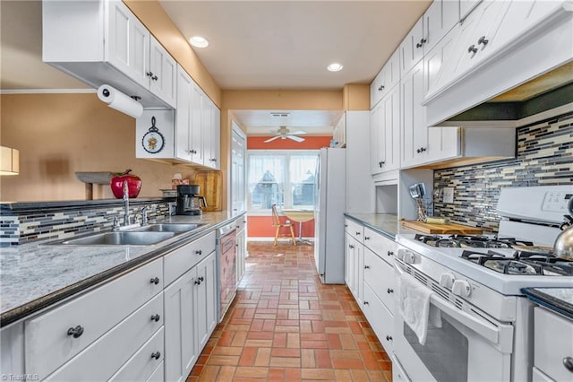 kitchen with white cabinets, decorative backsplash, white appliances, and custom range hood