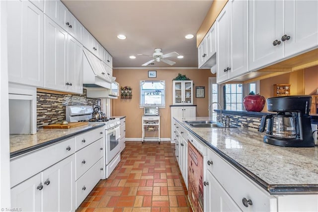 kitchen with white cabinets, sink, and gas range gas stove