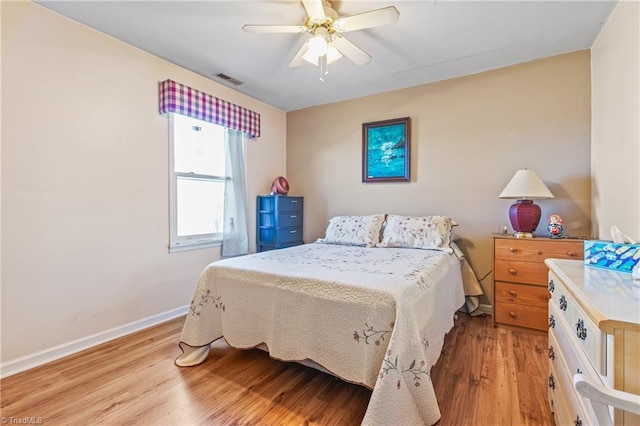 bedroom with ceiling fan and light hardwood / wood-style flooring