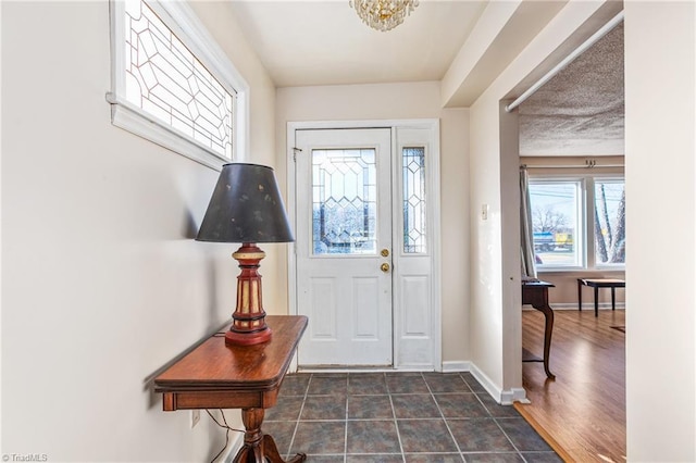 entryway with a chandelier and dark hardwood / wood-style flooring