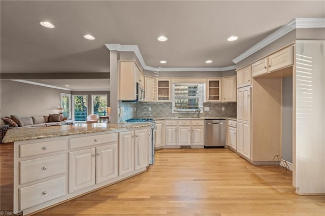 kitchen featuring light stone countertops, stainless steel appliances, tasteful backsplash, light hardwood / wood-style flooring, and kitchen peninsula