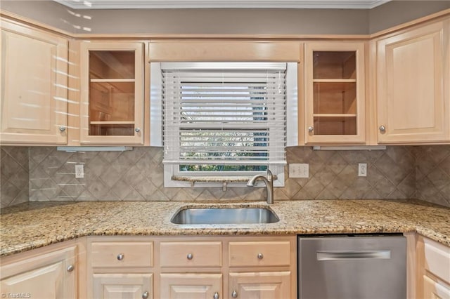 kitchen featuring tasteful backsplash, light stone countertops, dishwasher, and sink