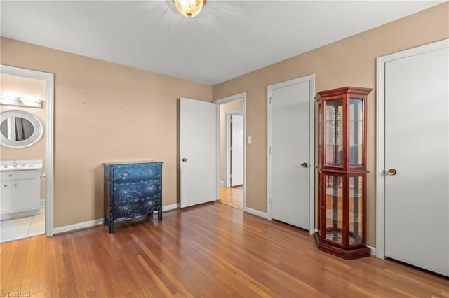 interior space featuring hardwood / wood-style floors, sink, and ensuite bath