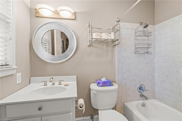 full bathroom with toilet, vanity, and tiled shower / bath