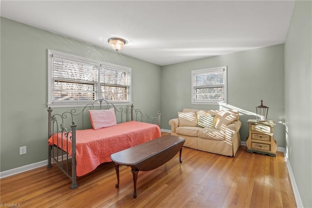 bedroom featuring light hardwood / wood-style floors and multiple windows