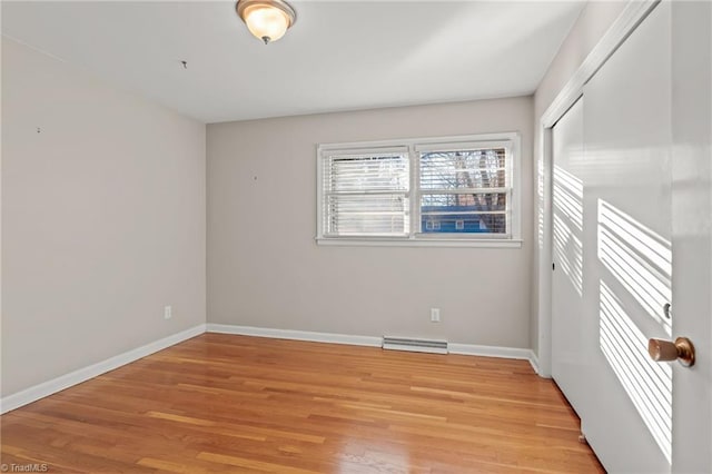 empty room with light hardwood / wood-style flooring