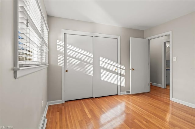 unfurnished bedroom with light hardwood / wood-style floors and a closet