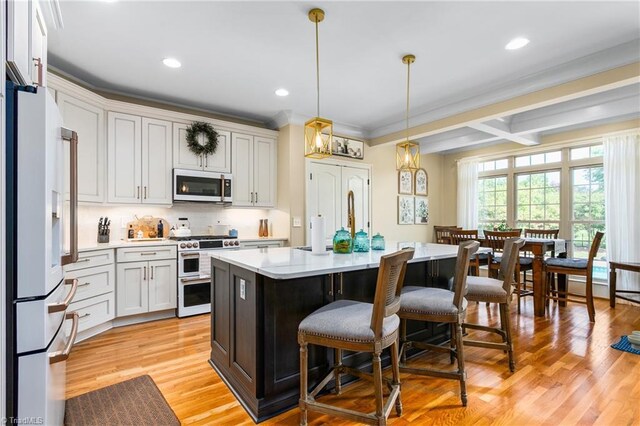 3303 Tanner Ct, Summerfield, NC 27358 - kitchen featuring a breakfast bar area, a center island, white appliances, light countertops, and tasteful backsplash