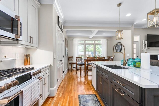 3303 Tanner Ct, Summerfield, NC 27358 - kitchen with a sink, stainless steel gas range oven, recessed lighting, light wood finished floors, and decorative backsplash