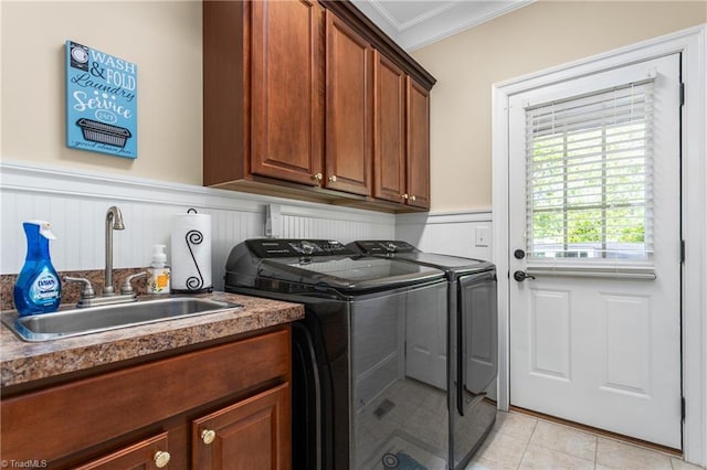 3303 Tanner Ct, Summerfield, NC 27358 - washroom with a sink, cabinet space, crown molding, wainscoting, and independent washer and dryer